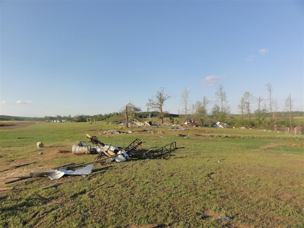 Pieces of a barn scattered in a field from the winds of a tornado.